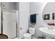 Bathroom with a modern glass shower, toilet, and sink with a round mirror at 2207 Wimberly Woods Dr, Sanford, NC 27330