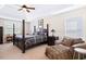 Bedroom with tray ceiling, ceiling fan, and four-poster bed with plaid bedding at 2207 Wimberly Woods Dr, Sanford, NC 27330