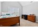 This bedroom has neutral walls with a bed and a chest of drawers at 2207 Wimberly Woods Dr, Sanford, NC 27330
