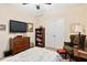 Comfortable bedroom features neutral walls, a ceiling fan, TV, and access to the closet at 2207 Wimberly Woods Dr, Sanford, NC 27330
