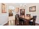 Elegant dining room with dark wood table, chandelier, and view to the kitchen at 2207 Wimberly Woods Dr, Sanford, NC 27330