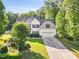 Well-maintained two-story home with a manicured lawn and attached garage at 2207 Wimberly Woods Dr, Sanford, NC 27330