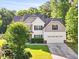 Charming two-story home with a well-manicured lawn, mature trees, and a two-car garage at 2207 Wimberly Woods Dr, Sanford, NC 27330