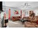 Open living room with comfortable couches, bright windows, and nearby kitchen area at 2207 Wimberly Woods Dr, Sanford, NC 27330
