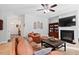 Living room with a fireplace, TV, and comfortable leather seating at 2207 Wimberly Woods Dr, Sanford, NC 27330