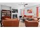 Spacious living room with a fireplace, built-in bookshelves, and comfortable leather furniture at 2207 Wimberly Woods Dr, Sanford, NC 27330