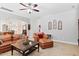 Relaxing living room area showcasing a ceiling fan and comfortable leather seating at 2207 Wimberly Woods Dr, Sanford, NC 27330