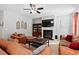 Comfortable living room showcasing a fireplace, mounted TV, and plush leather seating at 2207 Wimberly Woods Dr, Sanford, NC 27330