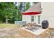 Back patio with a hot tub, dining table, and grill, perfect for entertaining at 2207 Wimberly Woods Dr, Sanford, NC 27330