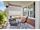 Cozy covered patio with a table, chairs, and stylish outdoor rug at 2207 Wimberly Woods Dr, Sanford, NC 27330