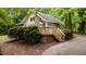Charming home featuring stone accents, a spacious deck, and surrounded by lush greenery at 222 Sagamore Dr, Louisburg, NC 27549