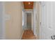 Hallway with wood floors leading to carpeted bedroom and storage closets at 222 Sagamore Dr, Louisburg, NC 27549