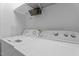 Convenient laundry room features a washer, dryer, and upper shelving at 222 Sagamore Dr, Louisburg, NC 27549
