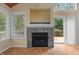 Living area showcasing stone fireplace, light-filled windows, and sliding doors to outdoor deck at 222 Sagamore Dr, Louisburg, NC 27549