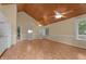 Open-concept living room with hardwood floors, light yellow walls, and vaulted wood ceiling at 222 Sagamore Dr, Louisburg, NC 27549