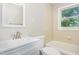 Bright bathroom featuring white vanity with brushed nickel faucet and shower-tub combination at 2312 Shannon St, Raleigh, NC 27610