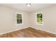 Bedroom with laminate flooring and natural light streaming through windows at 2312 Shannon St, Raleigh, NC 27610