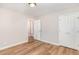 Bedroom with laminate flooring, fresh paint, closet and entryway into another room at 2312 Shannon St, Raleigh, NC 27610