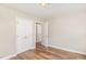 Neutral bedroom showcasing wood-look flooring and a double door closet for ample storage at 2312 Shannon St, Raleigh, NC 27610