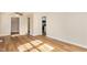 Open living area with vinyl floors, ceiling fan and view into the kitchen at 2312 Shannon St, Raleigh, NC 27610