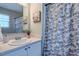 Well-lit bathroom includes a shower curtain and a vanity with a decorative mirror at 2459 Bay Harbor Dr, Raleigh, NC 27604