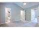 Spacious bedroom with carpet, multiple doors, and access to an en-suite bathroom at 2459 Bay Harbor Dr, Raleigh, NC 27604
