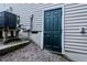 Basement entrance with a dark green door and siding at 2459 Bay Harbor Dr, Raleigh, NC 27604