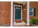 Front door of brick home with green door and storm door. Well lit and welcoming at 2459 Bay Harbor Dr, Raleigh, NC 27604