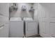 Functional laundry room with white washer and dryer, and storage shelves at 2459 Bay Harbor Dr, Raleigh, NC 27604