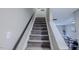Stairway to second floor with carpeting. The dining and living area are visible at top of stairs at 2459 Bay Harbor Dr, Raleigh, NC 27604