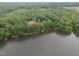 Scenic aerial view of lakefront property with docks and lush greenery at 249 Fisherman Point Rd, Roxboro, NC 27574