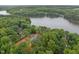 Beautiful aerial view of a lakeside home surrounded by lush greenery and expansive lake views at 249 Fisherman Point Rd, Roxboro, NC 27574