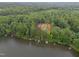 Scenic aerial view of lakefront properties surrounded by lush greenery and docks along the calm water at 249 Fisherman Point Rd, Roxboro, NC 27574