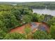 Aerial perspective of a lakefront community surrounded by lush trees and serene water views at 249 Fisherman Point Rd, Roxboro, NC 27574