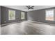 Bedroom featuring modern vinyl floors, neutral paint, and double windows offering ample natural light at 249 Fisherman Point Rd, Roxboro, NC 27574