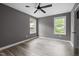 Comfortable bedroom with ceiling fan, modern paint, and natural light from two windows at 249 Fisherman Point Rd, Roxboro, NC 27574