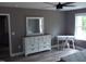 This bedroom includes a large dresser with mirror, a desk, and a ceiling fan at 249 Fisherman Point Rd, Roxboro, NC 27574