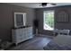 Bedroom features ample storage space with a large dresser and desk area by the window at 249 Fisherman Point Rd, Roxboro, NC 27574