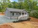 Charming one-story home showcasing gray siding, a stone foundation, and a welcoming front porch at 249 Fisherman Point Rd, Roxboro, NC 27574