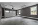 Spacious two-car garage with sealed concrete flooring and natural light from windows at 249 Fisherman Point Rd, Roxboro, NC 27574