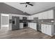 Updated kitchen featuring white cabinets, granite countertops, stainless steel appliances, and durable new wood-look floors at 249 Fisherman Point Rd, Roxboro, NC 27574