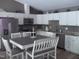 Bright eat-in kitchen features updated appliances, white cabinets, and modern countertops at 249 Fisherman Point Rd, Roxboro, NC 27574