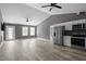 Open-concept living space with vaulted ceiling, new flooring, stainless steel refrigerator and plenty of natural light at 249 Fisherman Point Rd, Roxboro, NC 27574
