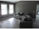 Living room featuring couches and two windows, with light colored floors at 249 Fisherman Point Rd, Roxboro, NC 27574