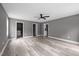 Spacious living room with modern flooring leads to laundry, main bedroom and hall bathroom with ample closet space at 249 Fisherman Point Rd, Roxboro, NC 27574