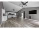 Open-concept layout with modern flooring, stainless kitchen appliances, and vaulted ceilings offers easy entertaining at 249 Fisherman Point Rd, Roxboro, NC 27574