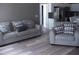 Living room with seating and view into the kitchen, with light colored floors at 249 Fisherman Point Rd, Roxboro, NC 27574