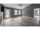 Living room with new wood-look flooring, French doors to the deck and vaulted ceiling offers abundant natural light at 249 Fisherman Point Rd, Roxboro, NC 27574