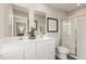 Elegant bathroom with dual vanity and glass-enclosed shower, designed for modern comfort and convenience at 260 Day Farm Dr, Lillington, NC 27546