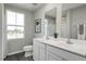 Bright bathroom featuring a double vanity, toilet, and mirror, perfect for a clean and fresh look at 260 Day Farm Dr, Lillington, NC 27546